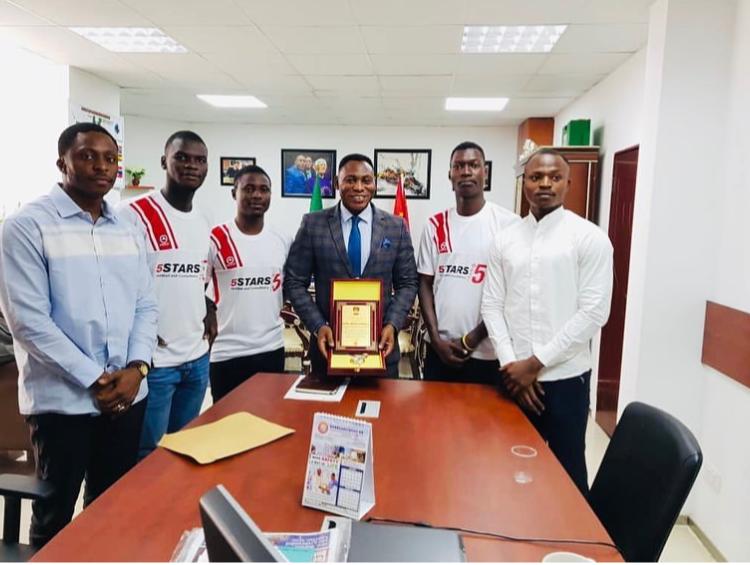 5Stars team presenting an award to Daniel Amokachi at his office