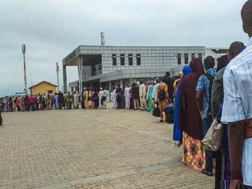 Passengers queueing up at a train station