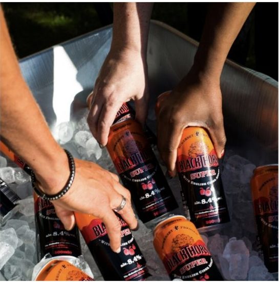 Friends reaching for BlackThorn Super Apple Cider